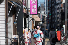 Japanese urban street scene with women dressed in Kimonos with backs to camera, Asakusa, Japan