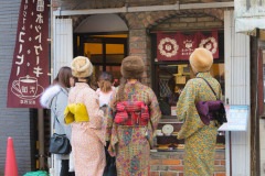 Group of young Japanese women dressed in Kimono, window shopping. Asakusa, Japan, 2018
