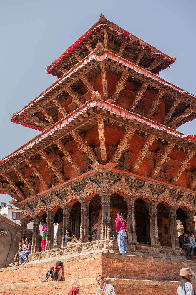 Temple with young people on steps to temple with blue sky in background, Durbar Square, Kathamandu, Nepal. March 2014