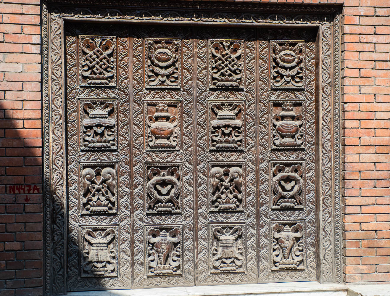 Carved wooden door on Hanuman Dhoka old Royal Palace, before earthquake in April 2015. Durbar Square in Kathmandu, Nepal March 2014